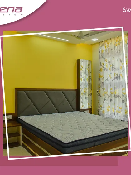 A simple yet elegant bedroom design with a bright yellow accent wall. The bed features a grey upholstered headboard with a diamond pattern, and the wardrobe includes a full-length mirror, adding functionality to the space.
