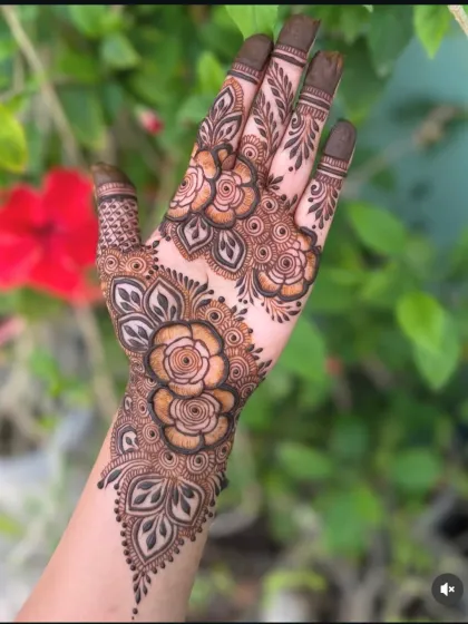 A stunning floral design that covers the back of the hand. The intricate rose patterns are perfect for an engagement or sangeet ceremony.