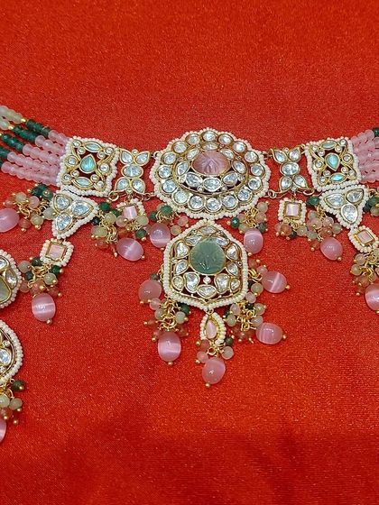 The product shot of the pastel pink and green choker set. This is a fantastic rental option for spring weddings or daytime events.