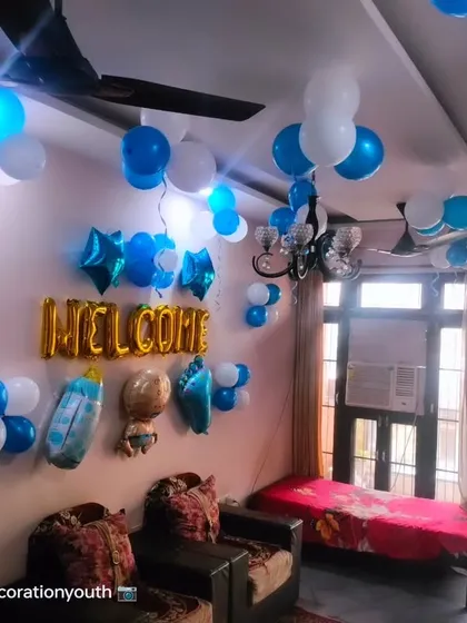 A simple "Welcome" baby boy room decoration. We used blue and white balloons and various baby-themed foil balloons to decorate the wall.