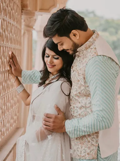 A close-up of the couple in their traditional pre-wedding attire. Her makeup is subtle yet defining, with a focus on her eyes and radiant skin.