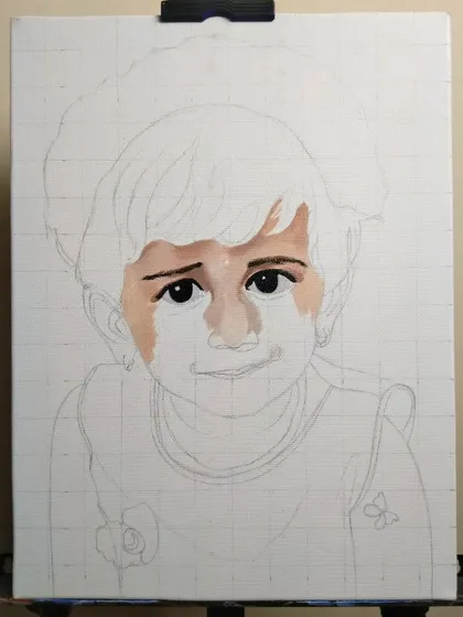 The very beginning of a commissioned child portrait. I start with a light pencil sketch on a gridded canvas and then begin carefully painting the eyes and surrounding skin tones.