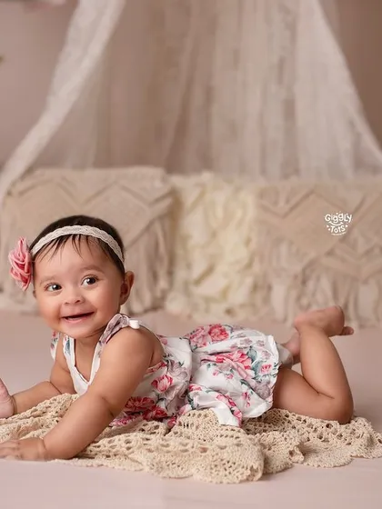 Daddy's little girl, Mommy's whole world. This little one's happy expression is beautifully captured in a simple, boho-chic setting.
