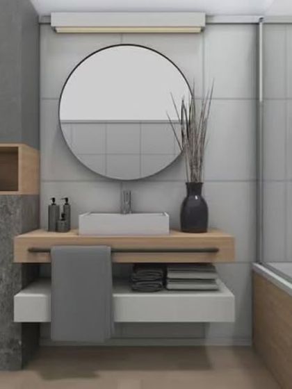 This bathroom combines grey marble and light wood tones for a soft, contemporary look. The floating vanity includes both open and closed storage for practicality.