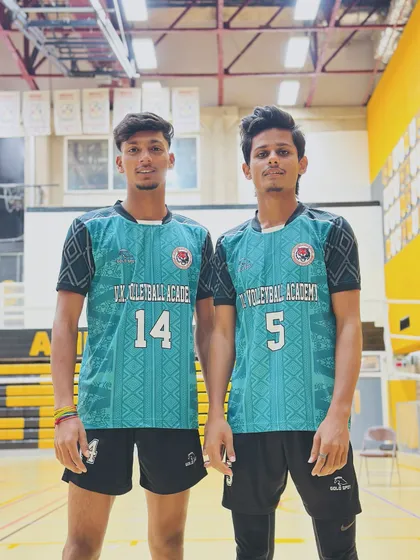 Two teammates standing together, showcasing the unity and brotherhood fostered within the UK Volleyball Academy.