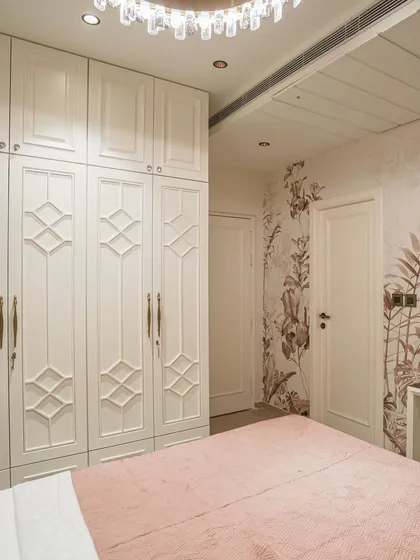 A view of the bedroom from image 46, showing the floral wallpaper accent.