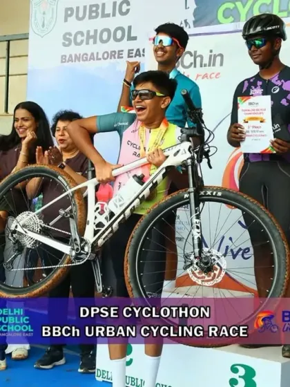 The pure joy of victory. A young champion celebrates his hard-earned win on the podium, lifting his bike in triumph at the DPSE Cyclothon. These are the moments we live for.