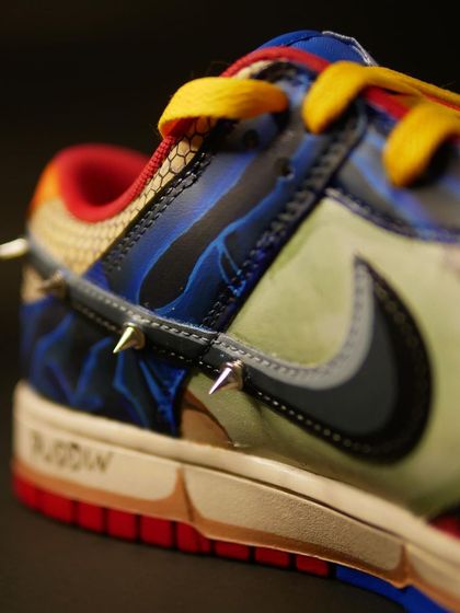 A macro shot of the spiked swoosh on the Harley Quinn custom. I used actual metal spikes to give it a 3D, tactile element.