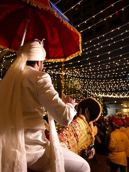 The groom's baraat entry on a horse, a classic and regal tradition.