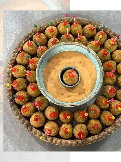 A platter of crispy fried bites served with a creamy dipping sauce. These are perfect for passing around at a party, offering a satisfying crunch with every bite.
