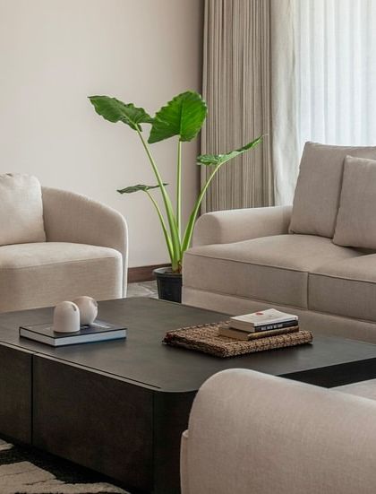 A detail shot of the seating arrangement in the Parishram residence, showing the clean lines of the sofa and the soft, inviting textures of the upholstery.