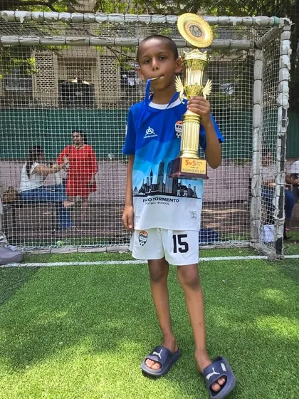 Aekansh Mahadik of the U-9 team posing with his championship trophy.