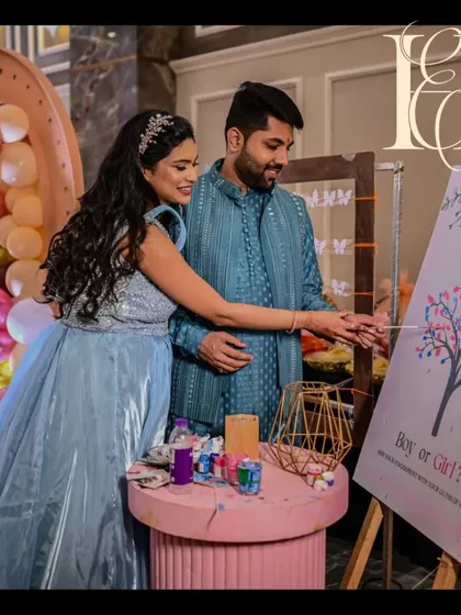An interactive fingerprint tree activity for a baby shower. The parents-to-be are adding their fingerprints to a "Boy or Girl?" tree, creating a beautiful keepsake while engaging with their guests in a fun way.