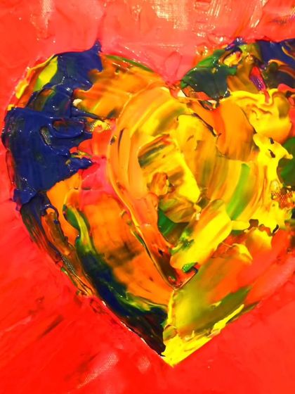 A close-up of a multi-colored heart with bold primary colors. The thick, impasto texture shows how I layer colors directly on the canvas, blending them to create new shades and a sense of raw energy.