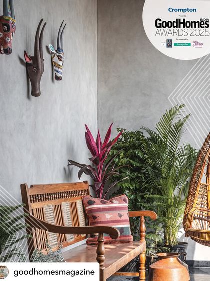 This image from the GoodHomes Awards feature highlights the traditional Indian aesthetic of the Prangan project's balcony, with its teak bench, cane swing, and ethnic artifacts.
