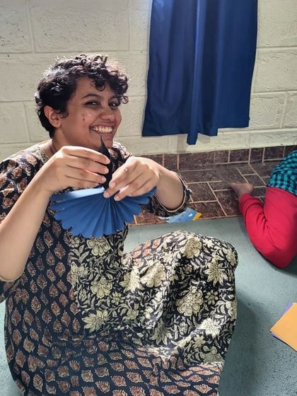 The joy of Diwali still shines in our hearts. A volunteer smiles while making crafts with the children.