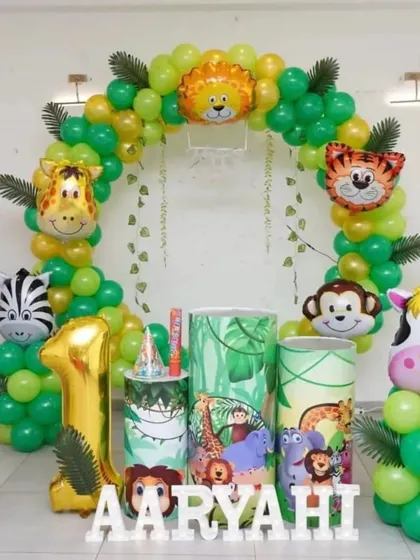 Let's get wild for your little one's first birthday with a fun jungle safari theme. This setup includes a balloon arch with animal foil balloons, jungle-themed props and cake stands, a large "1" foil balloon, and personalized name blocks.