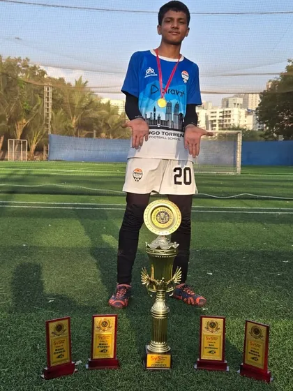 A proud player from our U15 team showcasing the trophies his team won.