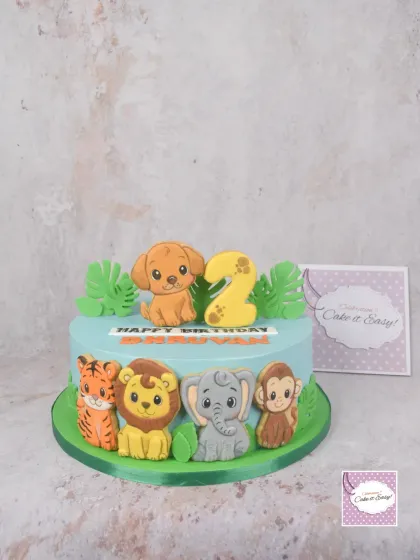 This cute animal-themed cake for a 2nd birthday is decorated with hand-painted cookie animals. Using cookies as toppers is a fantastic alternative to fondant.