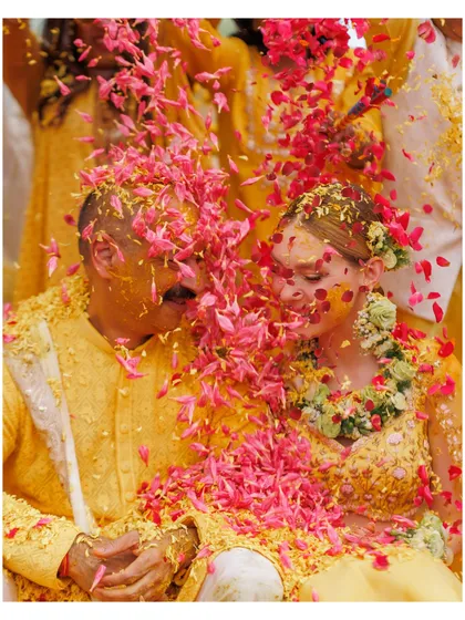 A shower of flower petals at a Goa Haldi ceremony. We help create these beautiful, photogenic moments.