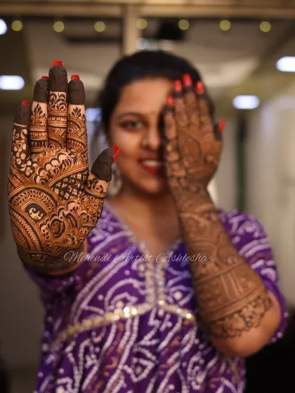 A happy client showing off her intricate mehendi. The joy on her face is why I love what I do.