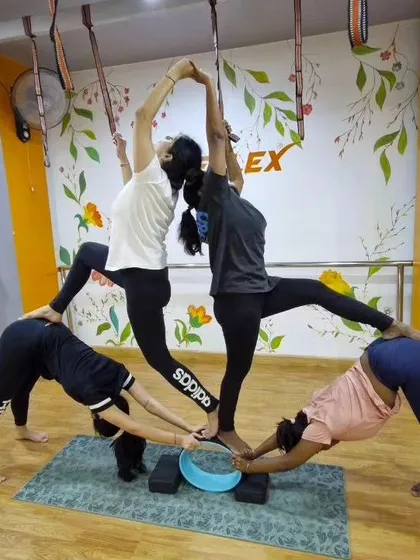 Our group partner workouts bring the energy you need to crush your goals. This four-person pose is a masterpiece of teamwork, balance, and support.