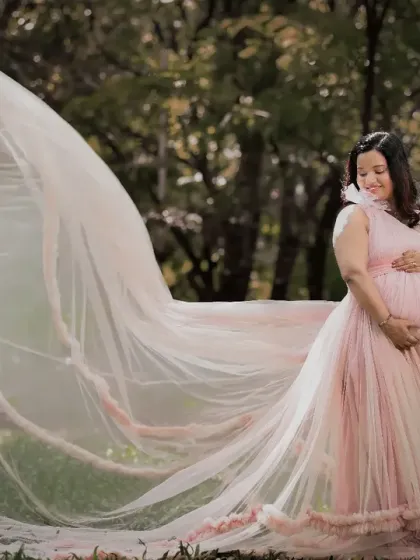 There's something magical about an outdoor maternity shoot. Here, we used the natural beauty of a Bangalore park and a flowing pink gown to create a serene and stunning portrait.