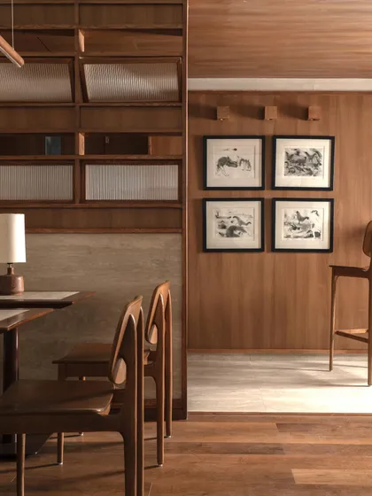 A view showing the interplay of different zones, with a wooden screen providing a sense of separation without closing off the space.