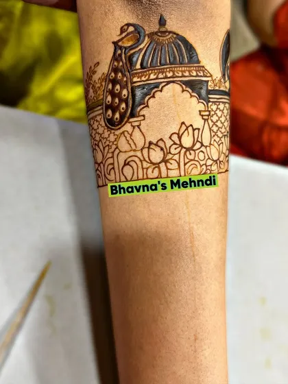 A beautiful cuff design for the arm, featuring a peacock perched on an architectural dome, surrounded by lotus flowers.