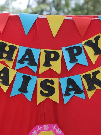 "Happy Baisakhi" banner against a bright red backdrop. I pay close attention to creating a festive and welcoming atmosphere with our decorations.
