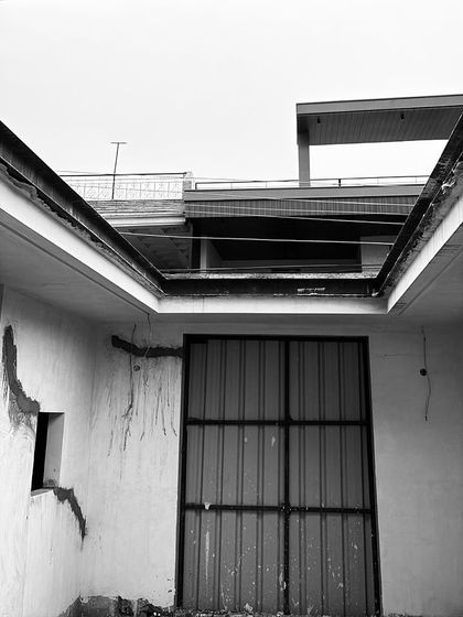 A view of the entrance area during early construction, showing the raw walls and the opening for the main door.