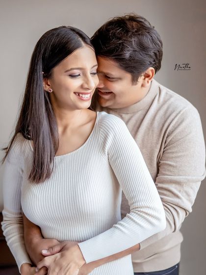 A cozy and loving portrait of a couple, perfect for a pre-maternity or engagement-style shoot.