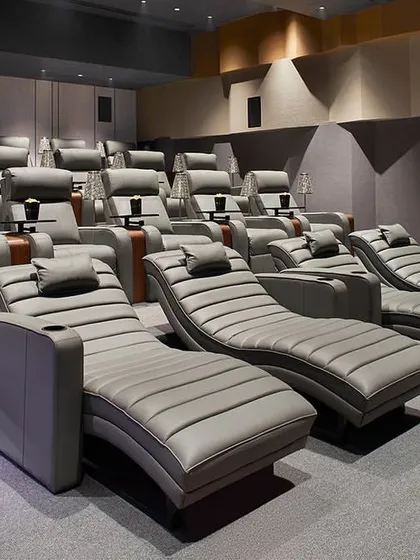 The tiered seating arrangement in the theater ensures clear sightlines for all guests, combining comfort with functional design.