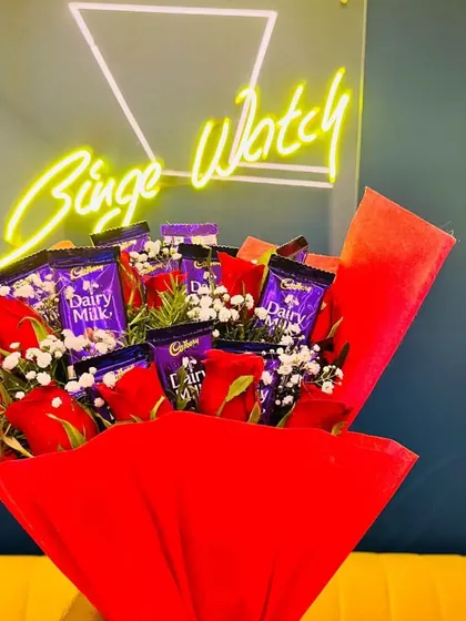 More than just flowers. We can create custom bouquets, like this one featuring red roses and Dairy Milk chocolates, to make your surprise even sweeter.