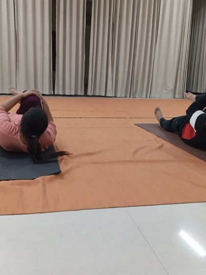 Participants practice a spinal twist as part of the Angamardana sequence, a process for building strength and inner clarity.