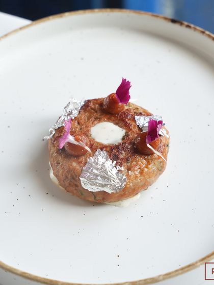 The Doughnut Kebab, plated and ready to be served. It’s a dish that perfectly balances rich, traditional flavors with a modern, whimsical form.