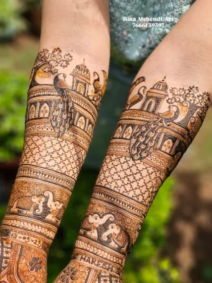A close-up of the forearm details in a traditional bridal mehendi, showcasing the intricate work in the elephant figures and the palace architecture.