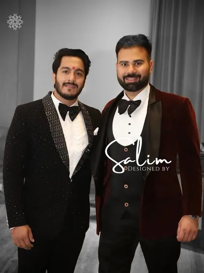 Two clients showcasing different tuxedo styles. One wears a classic maroon velvet tuxedo, while the other is in a black tuxedo with sparkling lapels.