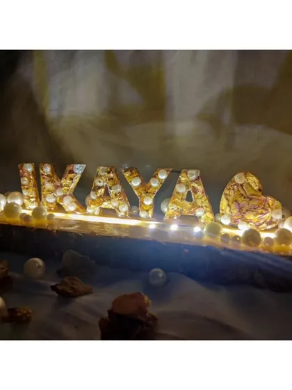 Light up your memories with a personalized LED name stand. I used a client's special varmala flowers to create this glowing 'IKAYA' monogram on a rustic wood base, turning their wedding keepsake into a beautiful piece of home decor.