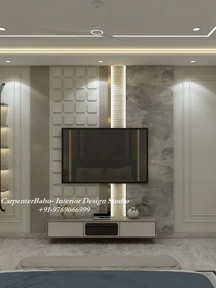 The TV wall in this bedroom is a work of art, with a mix of 3D panels, marble finish, and vertical fluting. The built-in display shelf adds a personal touch.