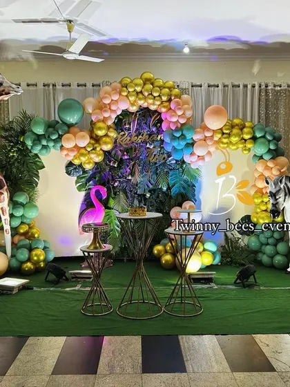 We went all out for this jungle-themed birthday party. The setup includes a lush green backdrop, life-sized animal props like a giraffe, elephant, and lion, and themed balloon arrangements to create a wild safari adventure.