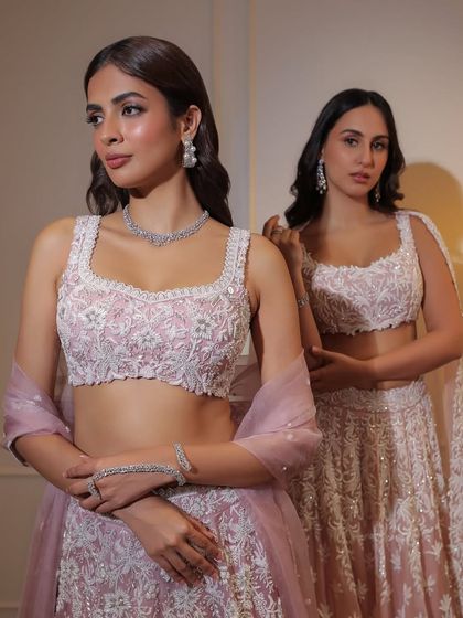 For the pastel pink bride, I suggest a soft diamond shimmer. This delicate diamond necklace and bracelet set perfectly complements a light, ethereal lehenga.