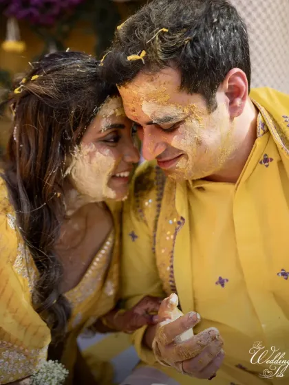 A sweet, intimate moment between the couple during their Haldi ceremony, their faces glowing with turmeric and happiness.