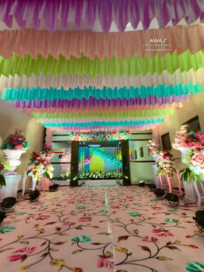 The full walkway, with a floral carpet and a ceiling of pastel drapes, creating a dreamy path for guests.