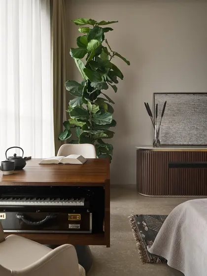 A closer look at the custom-designed music and study table. You can see the dedicated compartment for the harmonium, which is neatly concealed when not in use, maintaining the piece's clean lines as a modern work desk.