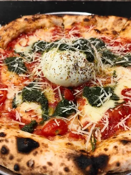 A true showstopper, my Burrata Pesto Pizza. I top a classic Neapolitan base with fresh pesto and a whole creamy burrata right in the center. It's a gourmet pizza experience that your guests will be talking about long after the party ends.