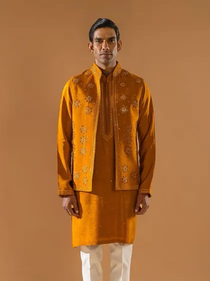 A full-length view of the mustard-yellow embroidered jacket and kurta set. This vibrant ensemble is a gateway to acing all your summer wedding looks with confidence and style.
