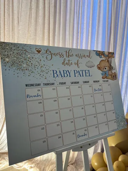 A fun and interactive "Guess the Arrival Date" calendar board, allowing guests to share their predictions and get excited for the baby's arrival.