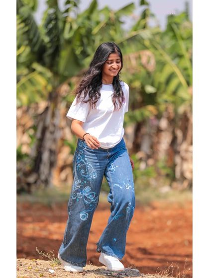 A fun shot of me in my hand-painted cosmic jeans. I love how art can transform everyday clothing into something that expresses your personality.