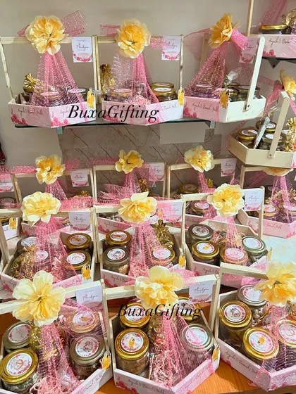 A display of the finished Haldi hampers, each topped with a flower and ready to be gifted to guests.
